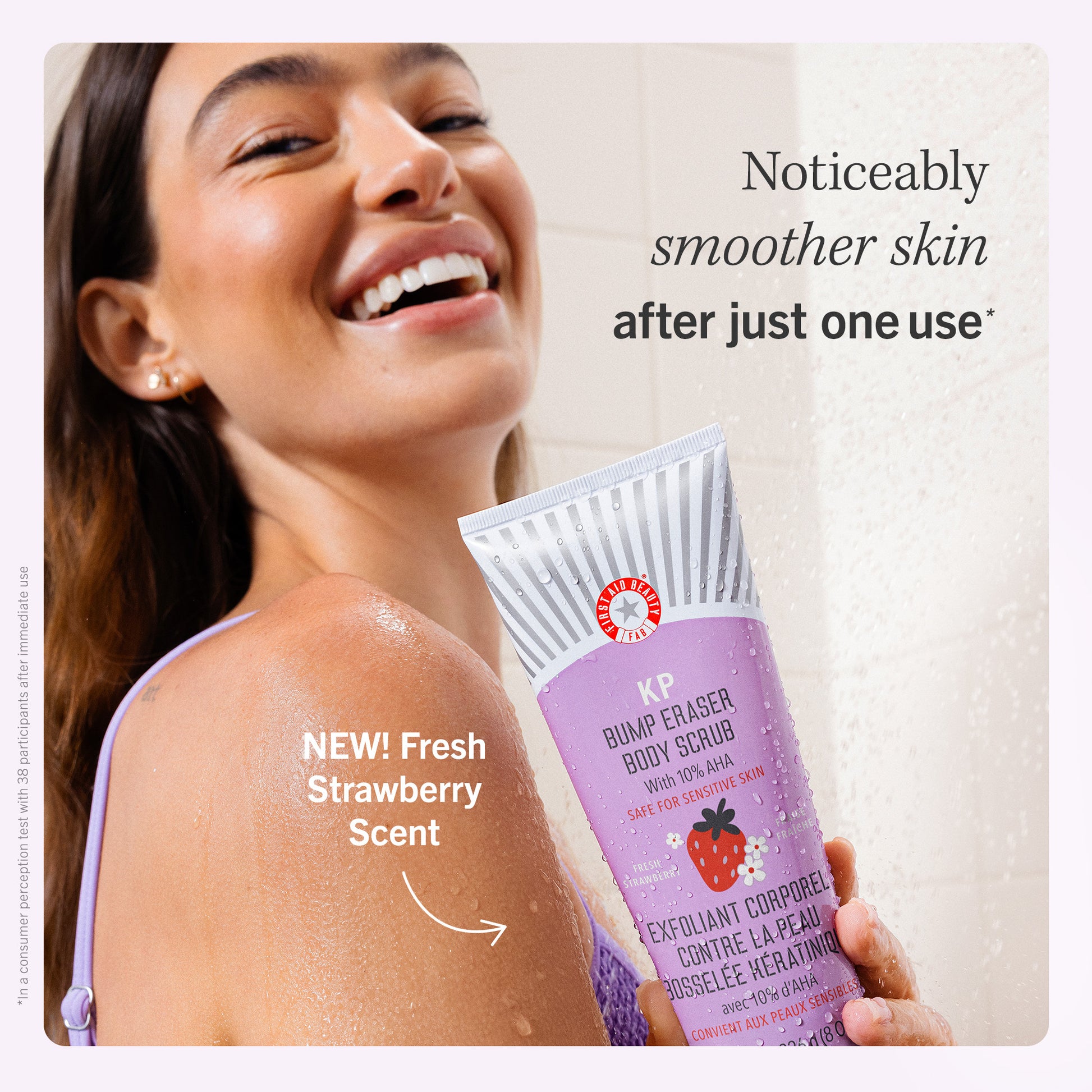 Model holding New Fresh Strawberry Scent KP Bump Eraser Body Scrub.  Noticeably smoother skin after just one use.