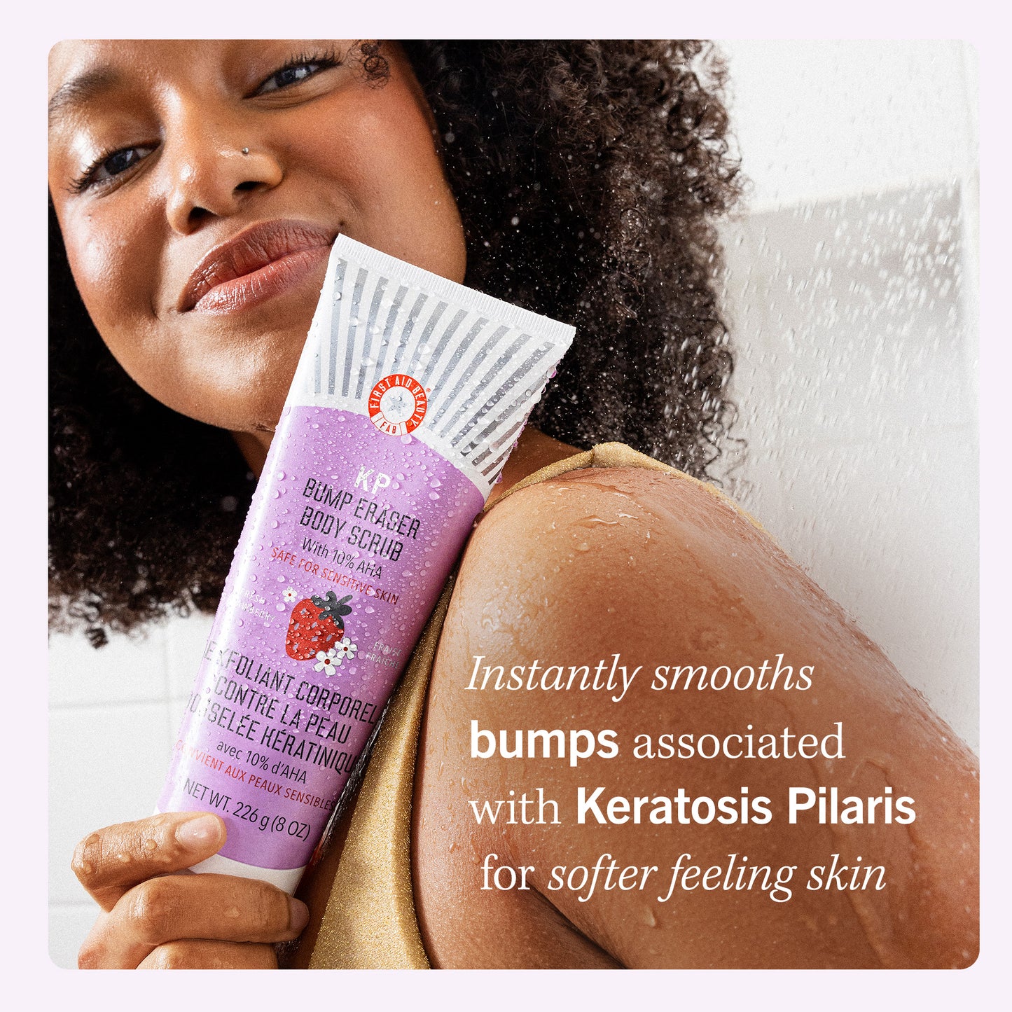 Model holding KP Bump Eraser Body Scrub Fresh Strawberry.  Instantly smooths bumps associated with Keratosis Pilaris for softer feeling skin.