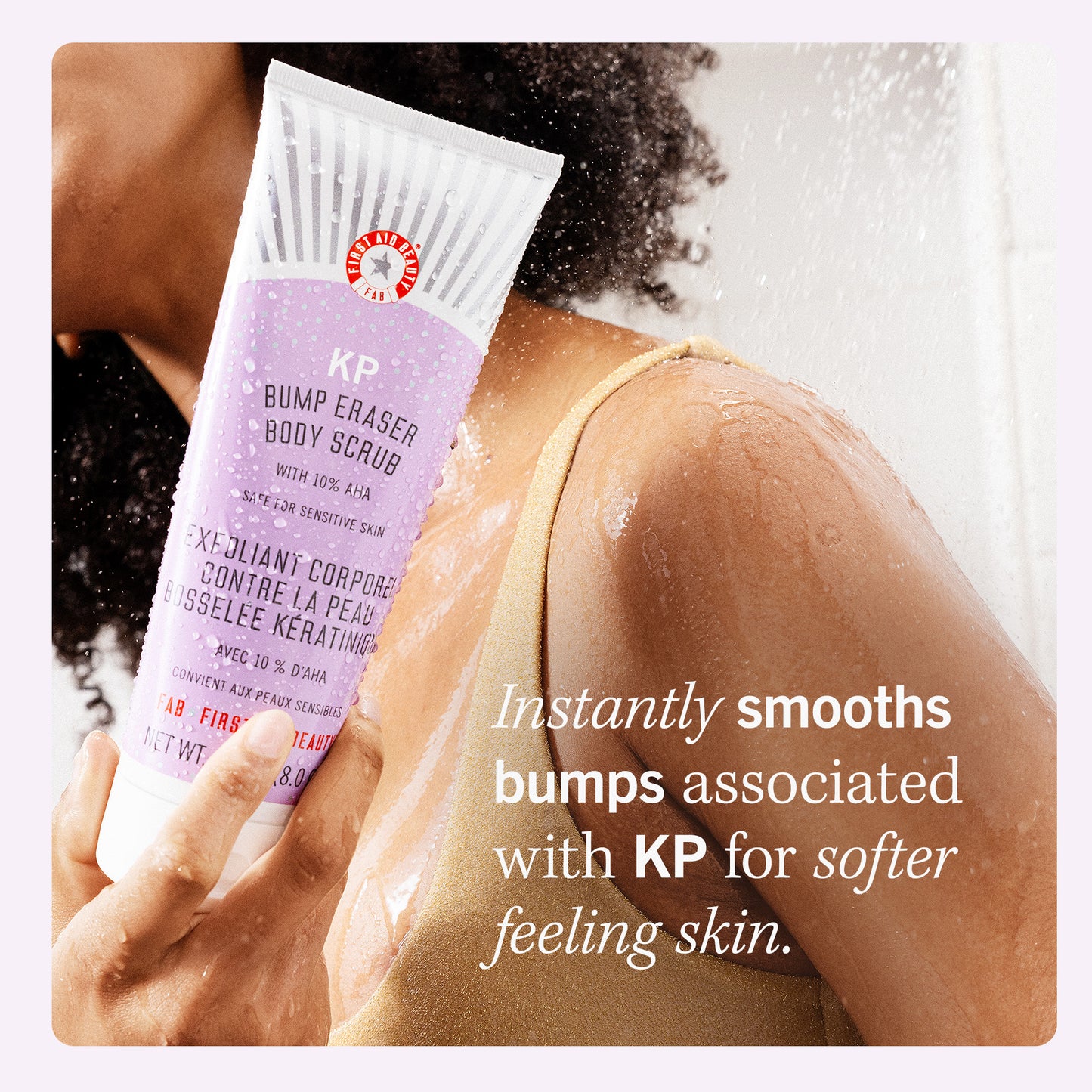 Model holding KP Bump Eraser Body Scrub.  Instantly smooths bumps associated with KP for softer feeling skin.