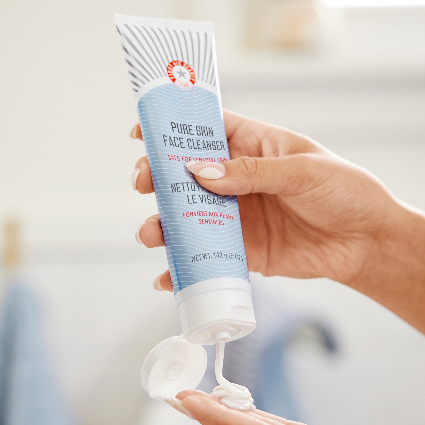 Model dispensing Face Cleanser into hand