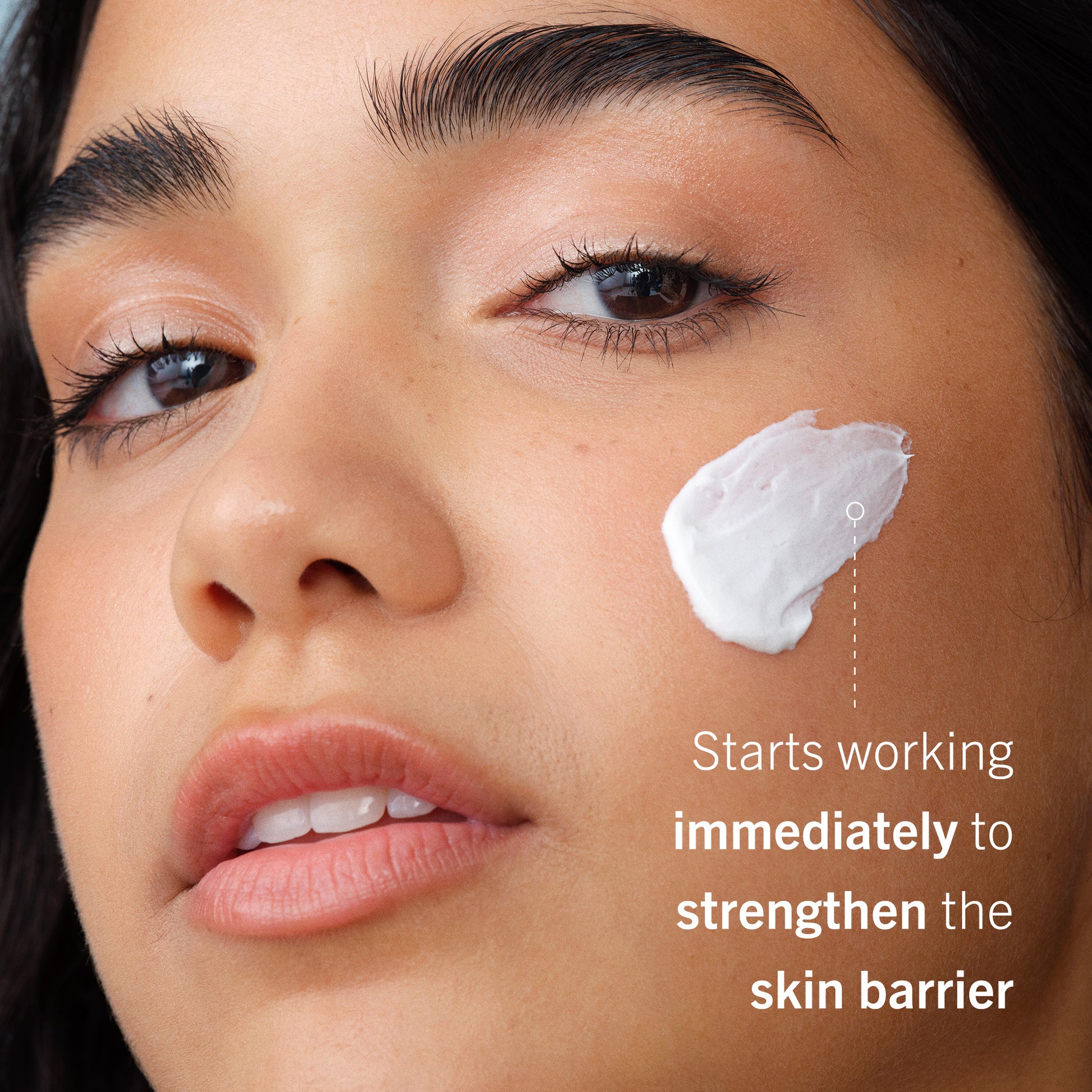 Ultra Repair Cream on model's face.  Starts working immediately to strengthen the skin barrier.